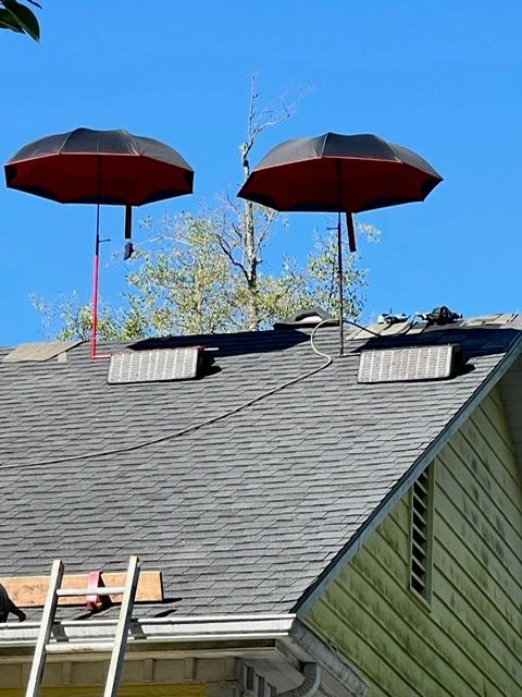 Two SunSafe Shield umbrella shades set up on Pitch Hopper wedges along a roof ridge