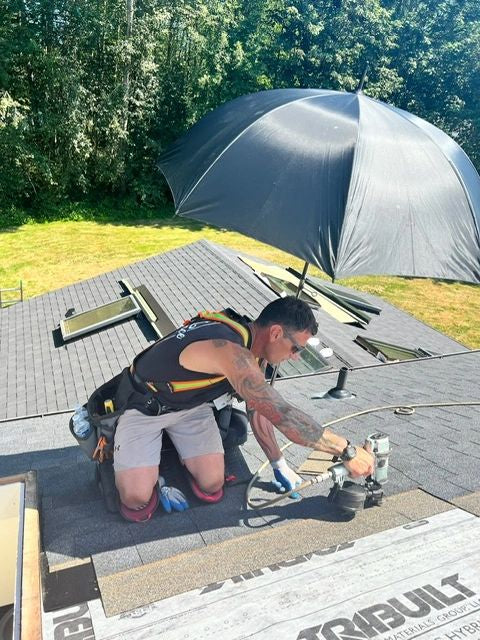 Roofer working in the shade of a SunSafe Shield attached to a Pitch Hopper